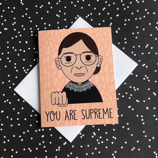 by Bored Inc. You Are Supreme RBG Ruth Bader Ginsburg Card. Tell your favorite gal she's SUPREME with this tribute to The Notorious RBG! Card is blank inside, comes with plain white envelope. Digitally printed using high quality, archival dye based inks on a heavyweight matte card. Measures 4 1/4 x 5 1/2 inches. FOLD Gallery Dtla.