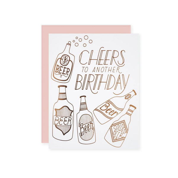 by The Good Twin. Cheers to Another Birthday Card details: Three color screen print on French Paper. Packed in a cello sleeve with corresponding envelope. Blank inside. Made in the USA. Size A2, 4.25 by 5.5 inches folded. Please note that due to everyone’s monitor displaying differently, the colors you see may vary.