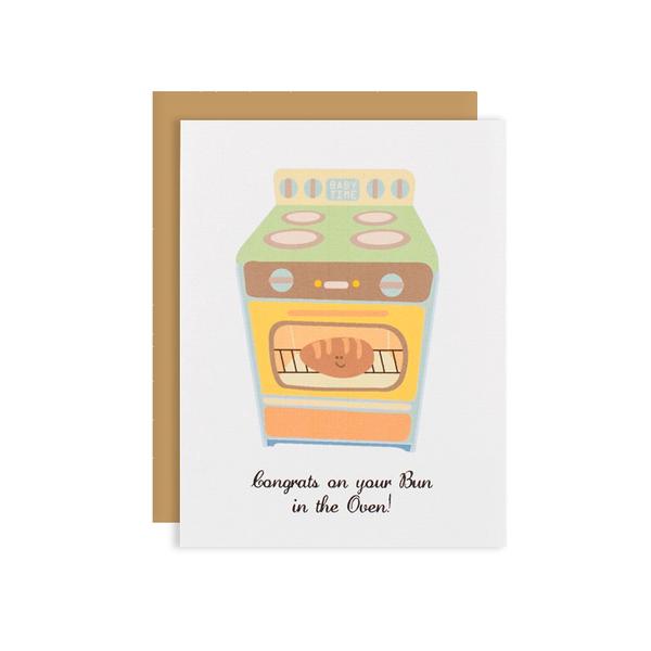 By Ilootpaperie. This folded Bun in the Oven Card is printed on 100lb cardstock with subtle embossed arctic white linen finish. Inside is blank for personal message. High quality, tan envelope with square flap included. Measures 4.25 x 5.5 inches. Also available in store at FOLD Gallery in DTLA.