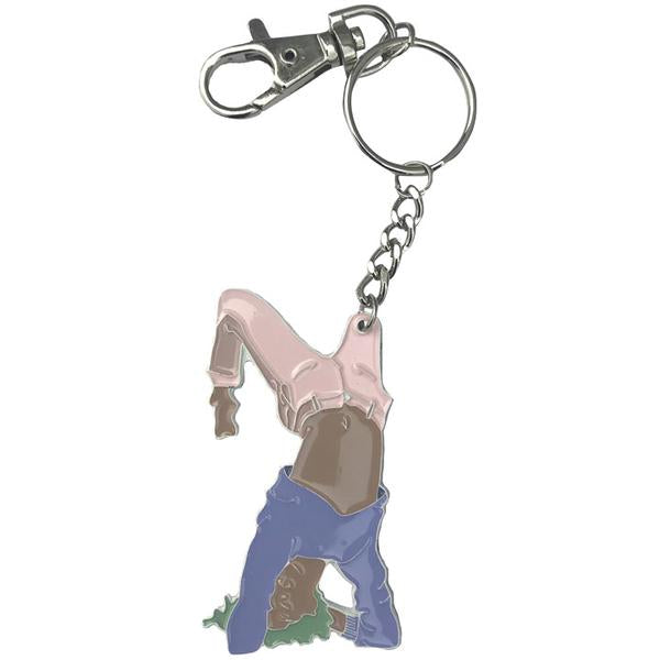 By Adele by Adele Jackson. Out of the Box Girl Keychain. Soft enamel white painted metal keychain with silver chain and closure. Measures 2 1/2 inches. Also available in store at FOLD Gallery DTLA.