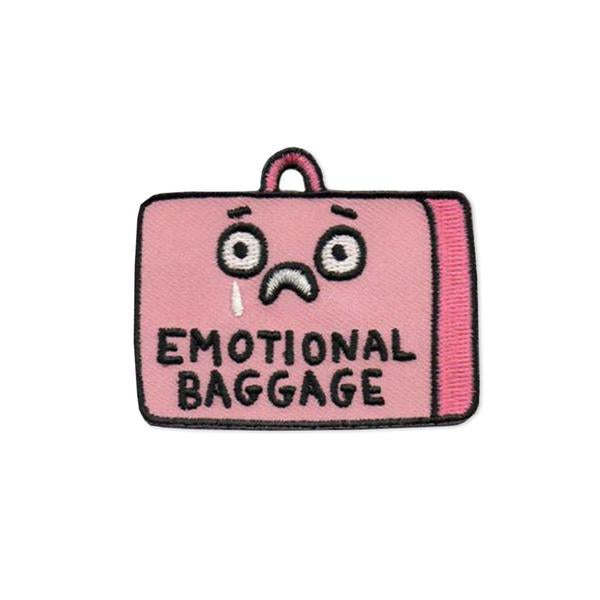 By Badge Bomb. Emotional Baggage Patch illustration by Gemma Correll. This iron on patch is packaged in a plastic free 4 x 5 hang card with UPC. Measures approximately 2.25 x 1.75 inches. 