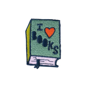 By Badge Bomb. Embroidered, felt, iron-on I Heart Books Patch by Allison Cole. Comes packaged in individual hang bag. Measures 1.5 x 2 inches. Also available in store at FOLD Gallery DTLA.