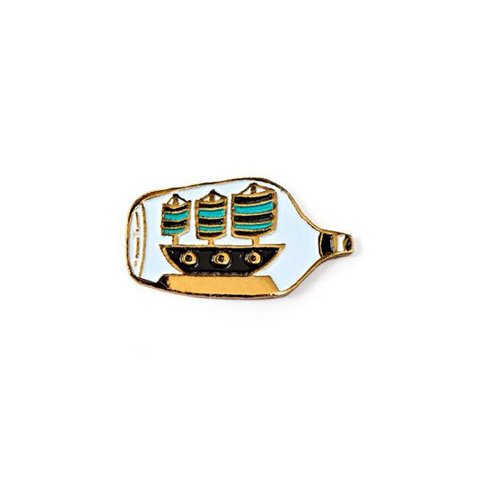 By Badge Bomb. Ship in a Bottle Pin. Soft enamel pin illustrated by artist Allison Cole. Measures 1.25 inches. Also available in store at FOLD Gallery DTLA.
