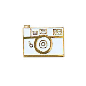 By Badge Bomb. White Retro Camera Pin. Soft enamel pin illustrated by Allison Cole. Measures 1.25 inches. FOLD Gallery Dtla.