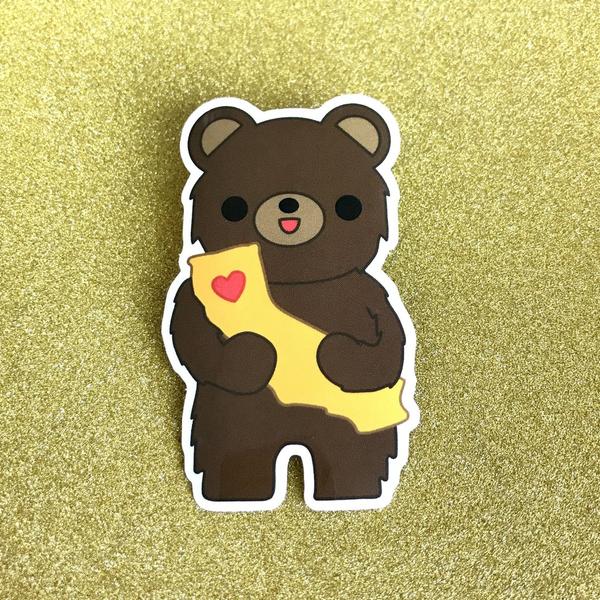 by Bored Inc. Waterproof California Bear Vinyl Sticker with an outdoor life of 3-5 years. Dishwasher safe. Also available in store at FOLD Gallery in DTLA. Measures approximately 3 inches tall.