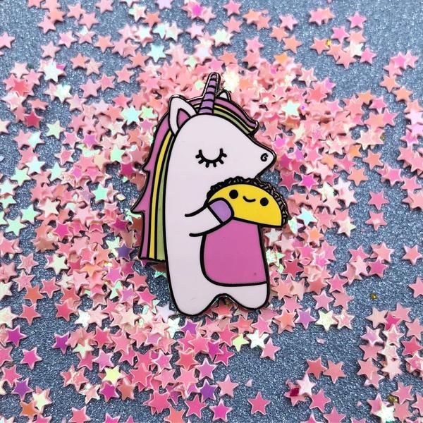 by Bored Inc. Unicorn and Taco Pin. Hard Enamel pin comes with a black rubber clutch. Measures 1 1/4 inches tall. Also available in store at FOLD Gallery DTLA.