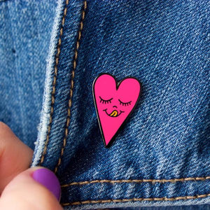 By Chris Uphues. This Neon Pink Heart Pin is made with super shiny black nickel and filled with smooth, high quality, enamel in neon pink and fluorescent orange. Pin comes with a rubber clutch for extra grip and mounted on Chris Uphues packaging. Perfect for gifting! Pin measures 1 inch tall. Also available in store at FOLD Gallery DTLA.