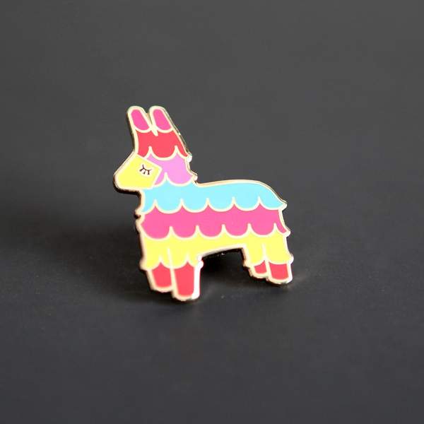 By City of Industry. Bring a little party wherever you go with this colorful Pinata Pin! Cloisonne pin with gold plating. Measures approximately 1.25 inch by 1 inch in size. Also available in store at FOLD Gallery DTLA.