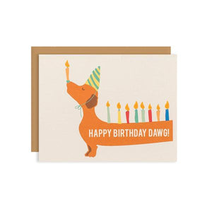By Ilootpaperie. This folded Bday Candle Dawg Card is printed on premium, rich and luxurious cream linen 100lb cardstock. Doxie dog's backside and tail extends to the back of the card (not pictured). Inside is blank for a personal message. High quality, tan envelope with square flap included. Measures 4.25 x 5.5 inches. FOLD Gallery Dtla.
