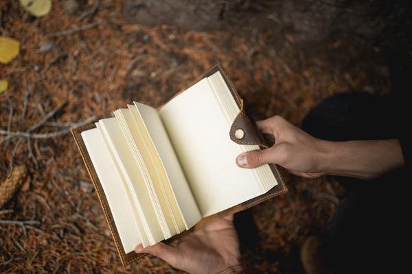 By Kodiak Leather. The Drifter Leather Journal in Antique Brown is the perfect travel companion. Made from Full Grain leather and complete with a snap button closure, this journal is the ultimate gift item for the world traveler or home body. 210 blank pages. Handmade artisan paper. Refillable. 5 x 7 x 2.5 inches.