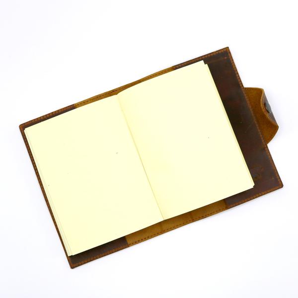 By Kodiak Leather. The Drifter Leather Journal in Antique Brown is the perfect travel companion. Made from Full Grain leather and complete with a snap button closure, this journal is the ultimate gift item for the world traveler or home body. 210 blank pages. Handmade artisan paper. Refillable. 5 x 7 x 2.5 inches.