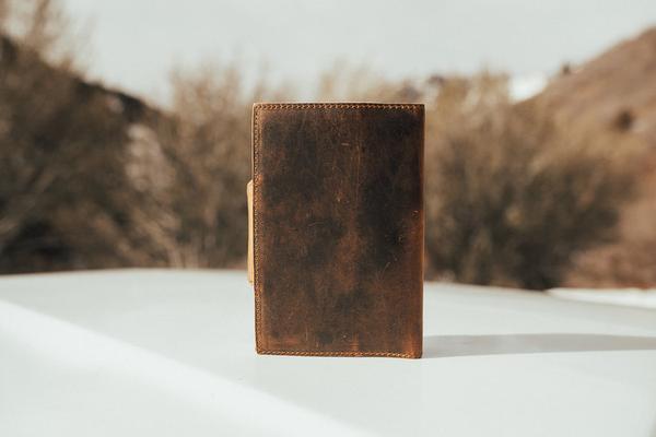 By Kodiak Leather. The Drifter Leather Journal in Antique Brown is the perfect travel companion. Made from Full Grain leather and complete with a snap button closure, this journal is the ultimate gift item for the world traveler or home body. 210 blank pages. Handmade artisan paper. Refillable. 5 x 7 x 2.5 inches.