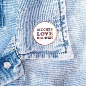 By Little Arrow. Bitches Love Brunch Lapel Pin on denim jacket.