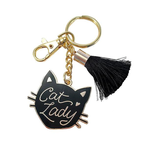 By Little Arrow. Cat Lady Keychain features a cloisonné hard enamel set in 22kt plated gold. Plated gold hardware and adorned with a silk tassel. Measures 2" wide x 4" tall. Also available in store at FOLD Gallery in DTLA.