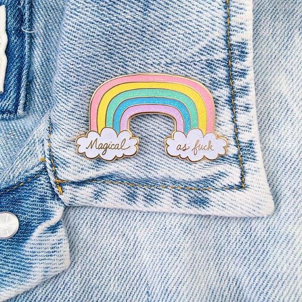 By Little Arrow. Magical AF Rainbow Pin. Measures 1.25 x 2 inches. Cloisonné hard enamel set in 22kt plated gold. Rubber clasp. Also available in store at FOLD Gallery DTLA.