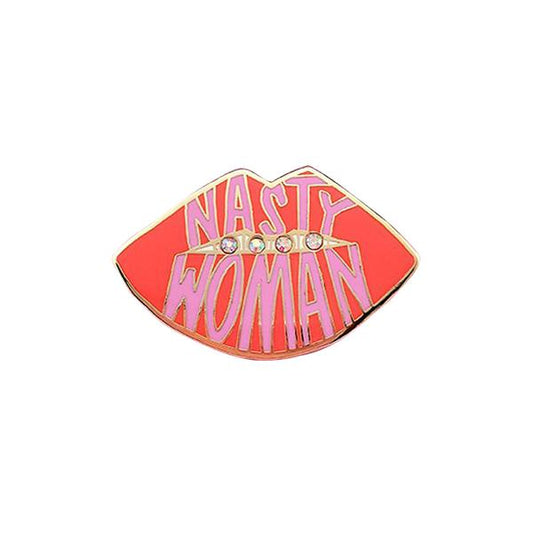 By Little Arrow. Nasty Woman Pin: Cloisonné enamel set in 22kt plated gold with 4 iridescent rhinestones. Rubber clasp. Measures 1.5 x 1.25 inches. Also available in store at FOLD Gallery DTLA.