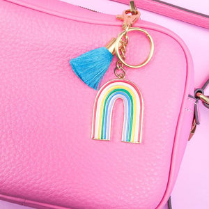 By Little Arrow Studio. Hard enamel Retro Rainbow Keychain in 22kt plated gold. Plated gold hardware and adorned with a silk tassel. Please note that due to everyone’s monitor displaying differently, the colors you see may vary. Measures 2 inch wide x 4.75 inch tall.