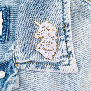 By Little Arrow. Unicorn Daydreams Glitter Pin. Cloisonné hard enamel set in 22kt plated gold. Dual pins with rubber backs. Available in White Iridescent or Pink Iridescent. Measures 1 x 1.75 inches. Also available in store at FOLD Gallery DTLA.