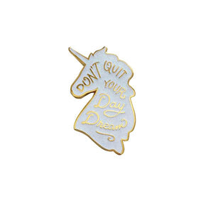 By Little Arrow. Unicorn Daydreams Glitter Pin. Cloisonné hard enamel set in 22kt plated gold. Dual pins with rubber backs. Available in White Iridescent or Pink Iridescent. Measures 1 x 1.75 inches. Also available in store at FOLD Gallery DTLA.