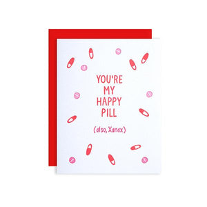 By Loudhouse Creative. Happy Pill Card: two-color letterpress printing, hand-drawn illustrations, 100% brilliant white cotton paper, blank inside, matching red envelope, cello sleeve packaging. Hand-printed on an antique letterpress in Los Angeles, California. Folded card measures 4.25 x 5.5 inches.