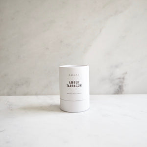 By Makana Candles. Amber Tarragon Candle: Resinous amber accented by vanilla and fennel, unveiling a heart of fresh tarragon, tuberose and basil, and finished with an accord of sensuous woods. Hand-poured in-house in small batches using simple, clean ingredients.
