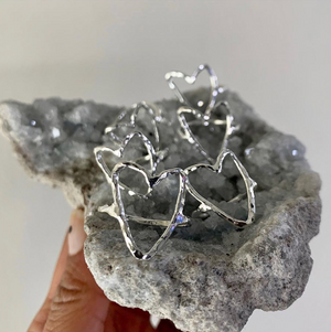 by Mouré Designs  The Wild Hearts Ring is hand hammered sterling silver. Each ring is unique and the heart shape may slightly vary from picture due to its handmade nature.  Available in size 6 or 7.   Please note that due to everyone’s monitor displaying differently, the colors you see may vary.