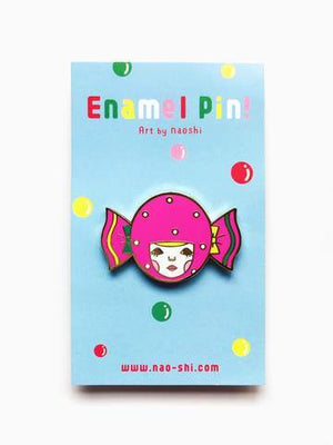 By Naoshi. Candy Girl Pin features: Hard enamel finish. Shiny gold metal plating. 2 posts and gold pin backs to hold securely in place. Packaged with a backing card in a plastic sleeve. Measures 1.0 x 1.6 inches. Also available in store at FOLD Gallery in DTLA.
