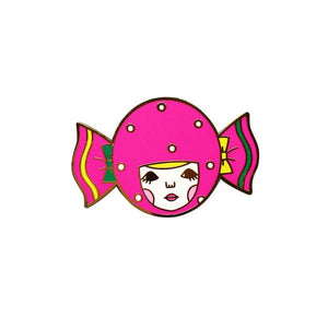 By Naoshi. Candy Girl Pin features: Hard enamel finish. Shiny gold metal plating. 2 posts and gold pin backs to hold securely in place. Packaged with a backing card in a plastic sleeve. Measures 1.0 x 1.6 inches. Also available in store at FOLD Gallery in DTLA.