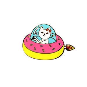 By Naoshi. Cat in a Donut Pin features: Hard enamel finish. Shiny gold metal plating. 2 posts and gold pin backs to hold securely in place. Packaged with a backing card in a plastic sleeve. Measures 1 x 1.6 inches. Also available in store at FOLD Gallery in DTLA.