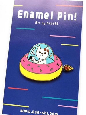 By Naoshi. Cat in a Donut Pin features: Hard enamel finish. Shiny gold metal plating. 2 posts and gold pin backs to hold securely in place. Packaged with a backing card in a plastic sleeve. Measures 1 x 1.6 inches. Also available in store at FOLD Gallery in DTLA.