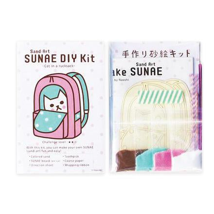 By Naoshi. With this Cat in a Rucksack SUNAE DIY Kit, you can make your own fun and easy SUNAE (Sand Art)! Contents of SUNAE DIY Kit: Colored Sand. SUNAE board (Pre-cut). Instructions. Coarse Paper. Toothpick. Wrapping Ribbon. Kit measures 4 x 6 inches. Also available in store at FOLD Gallery in DTLA.