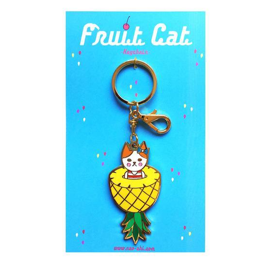 By Naoshi. Hard enamel Pineapple Cat Keychain. Comes on a backing card in a plastic sleeve. The Pineapple Cat measures 2.8 x 1.4 inches. Also available in store at FOLD Gallery DTLA.