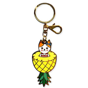 By Naoshi. Hard enamel Pineapple Cat Keychain. Comes on a backing card in a plastic sleeve. The Pineapple Cat measures 2.8 x 1.4 inches. Also available in store at FOLD Gallery DTLA.