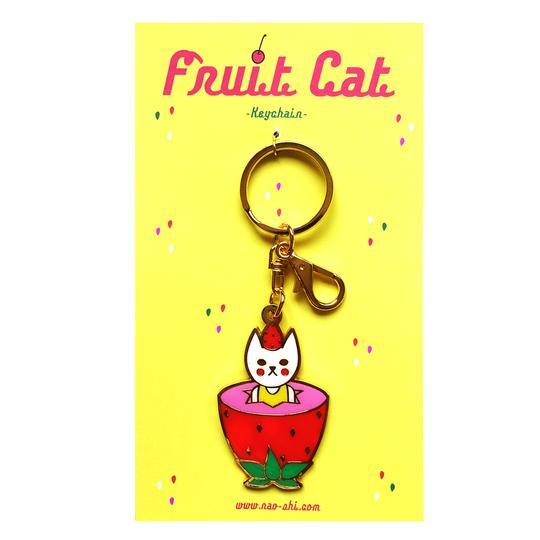 By Naoshi. Strawberry Cat Keychain. Hard enamel plus gold metal keychain. Comes on a backing card in a plastic sleeve. The Strawberry Cat measures 2.2 x 1.4 inches.