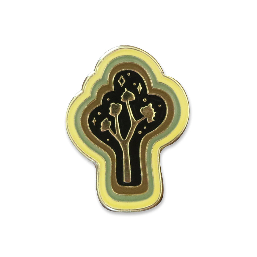 By Paper Parasol Press. Joshua Tree Magic Pin details: gold plated hard enamel cloisonne pin, rubber backing. Measures approx. 1"h x .75"w. Please note that due to everyone’s monitor displaying differently, the colors you see may vary.