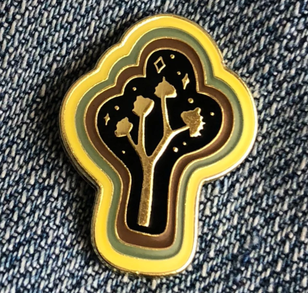 By Paper Parasol Press. Joshua Tree Magic Pin details: gold plated hard enamel cloisonne pin, rubber backing. Measures approx. 1"h x .75"w. Please note that due to everyone’s monitor displaying differently, the colors you see may vary.