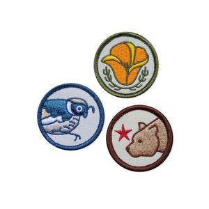By Poppy & Quail. Set of three iron-on embroidered CA Merit Badge Patches featuring California designs. Each patch measures 1.25 inches. Also available in store at FOLD Gallery in DTLA.