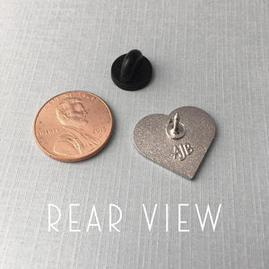 by Rather Keen. Silver-colored metal Book Lover Pin in turquoise/black enamel. Cloisonne hard enamel pin. Black rubber clasp. Measures 3/4 inches. Also available in store at FOLD Gallery.