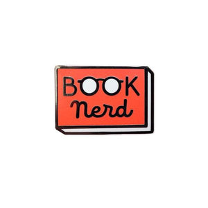 By Rather Keen. Hard enamel Book Nerd Pin. Bright red enamel and black metal with black rubber clasp. “When in doubt, go to the library.” —Hermione Granger. Measures 1 inch wide. Also available in store at FOLD Gallery.