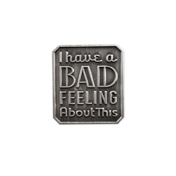 By Rather Keen. I Have a Bad Feeling About This - Star Wars Quote Pin. For when you're having bad feelings. Variations of this line can be heard in every Star Wars movie. Raised metal design (no enamel) in antique silver finish. Rubber clasp. Measures 7/8 x 3/4 inch (21 x 23 mm). Also available in store at FOLD Gallery DTLA.