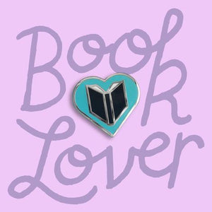 by Rather Keen. Silver-colored metal Book Lover Pin in turquoise/black enamel. Cloisonne hard enamel pin. Black rubber clasp. Measures 3/4 inches. Also available in store at FOLD Gallery.