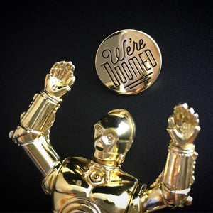 By Rather Keen. We're Doomed Star Wars C-3PO Quote Pin. For when your odds of successfully navigating an asteroid field are approximately 3,720 to 1. This pin features C-3PO's pessimistic dialogue in Star Wars. The reflective gold surface is just like C-3PO's head! Black enamel. Black rubber clasp. 3/4 x 3/4 inches. Also available in store at FOLD Gallery DTLA.