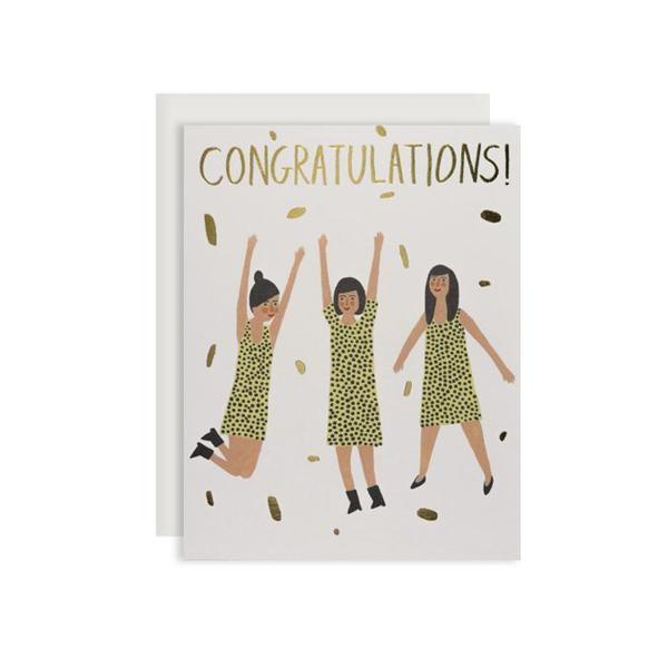 By Red Cap Cards. Three Women Congrats Foil Card. Foil. 100lb Heavyweight Cardstock. Illustrated by Kate Pugsley. Measures 4.25 x 5.5 inches. Also available in store at FOLD Gallery DTLA.
