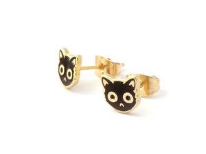 By SHOAL. Now you can wear grouchy cats on your ears whenever you want! Black Enamel Cat Face Stud Earrings. Metal composition: 22k gold-plated brass, nickel-free. 8mm (5/16 inch) width. 22k gold-plated earring backs. Packaged in a cute keepsake box, perfect for gift-giving!