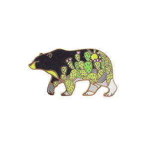 By Shoal. Hard enamel Cactus Black Bear Pin with shiny gold metal finish. Comes with a single pin post with rubber clutch back. Measures 1.25 inches wide. Also available in store at FOLD Gallery in DTLA.