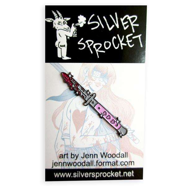 By Silver Sprocket. This Heart Dagger Pin is inspired by Jenn Woodall's Magical Beatdown mini-comic. Enamel pin comes with 2 rubber clutches. Measures 1.75 inches.