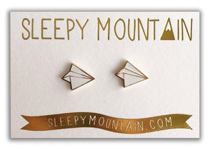 By Sleepy Mountain. Enamel Paper Airplane Earrings are 22k gold plated stainless steel. Includes butterfly backings as well as nylon stops. Measures 0.5 inches. Also available in store at FOLD Gallery DTLA.