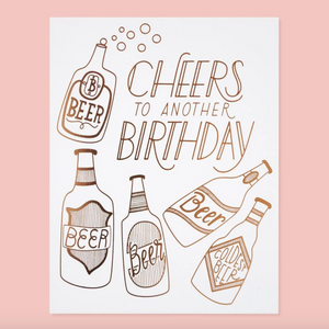 by The Good Twin. Cheers to Another Birthday Card details: Three color screen print on French Paper. Packed in a cello sleeve with corresponding envelope. Blank inside. Made in the USA. Size A2, 4.25 by 5.5 inches folded. Please note that due to everyone’s monitor displaying differently, the colors you see may vary.