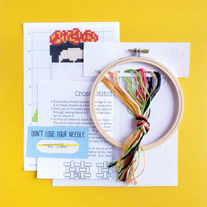 By The Stranded Stitch. Stitch some art appreciation with the Frida DIY Cross Stitch Kit. Kit Includes: Basic cross stitching instructions. Counted cross stitch pattern. DMC embroidery floss and color chart. 14 count white aida cloth. 5 inch Embroidery hoop. Needle. FOLD Gallery Dtla.
