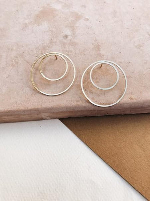 By TUMBLE. Double Hoop Gold Filled Earrings. 14k gold filled lightweight. All earring posts are sterling silver and comes with clear earring backs. Measures approximately 1.5 inches.